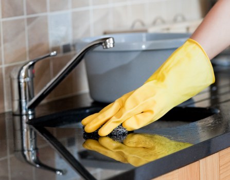 Living room sofa cleaning with vacuum and upholstery care